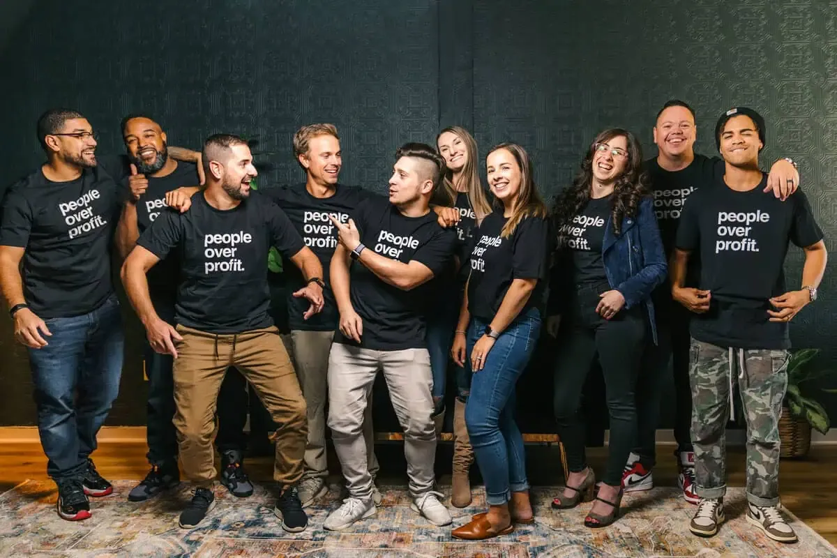The People First Property Solutions team in matching People Over Profit shirts